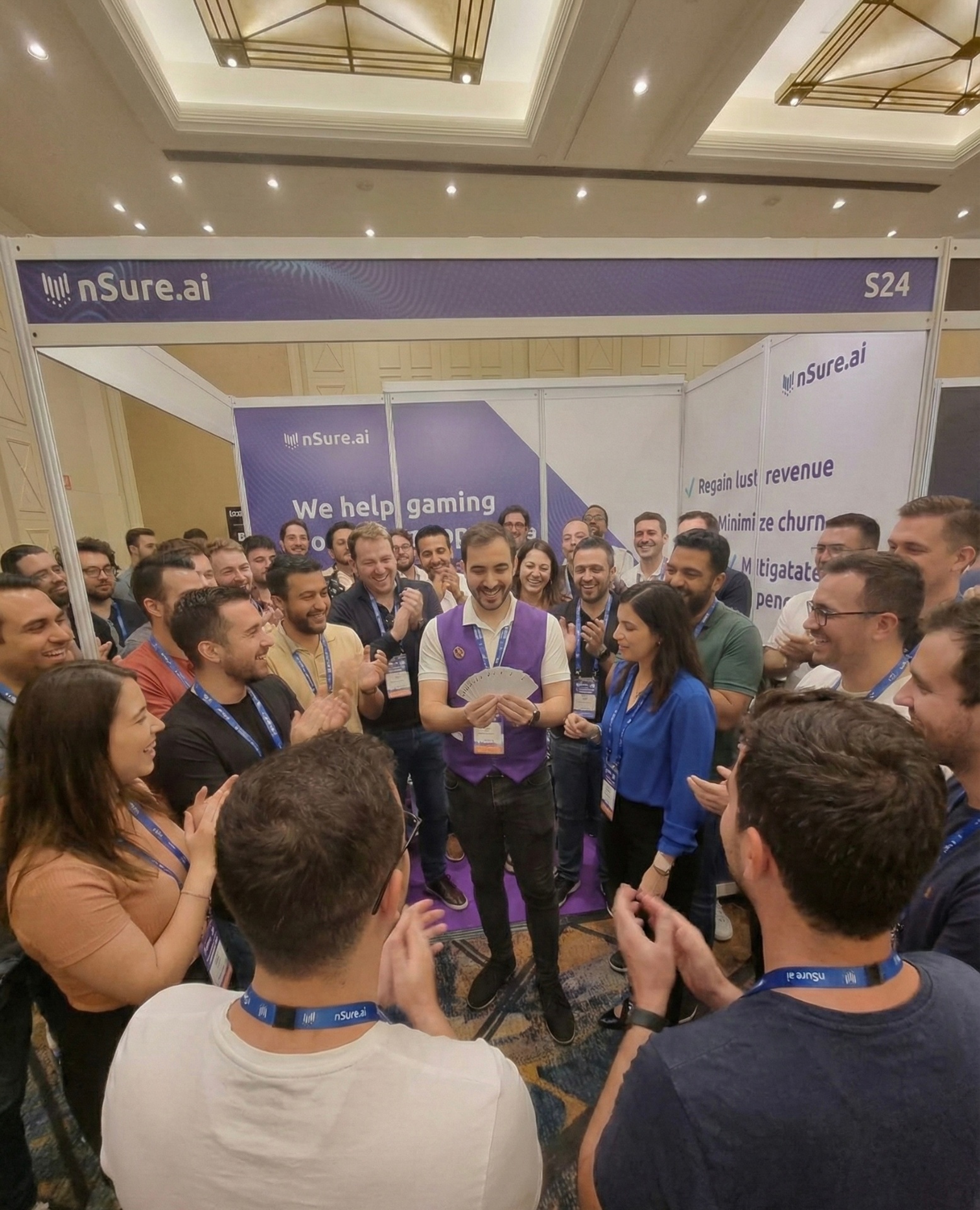 A crowd gathered around Neta Bresler at a trade-show booth